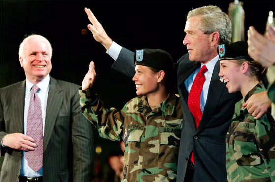 US PRESIDENT BUSH WAVES WITH US MILITARY PERSONNEL AT FT LEWIS