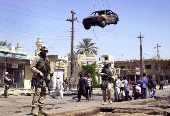 U.S.&nbsp;soldiers guard the site of&nbsp;an explosion in Hillah, Iraq, on Sunday after&nbsp;bomb blasts&nbsp;killed dozens of people there the day before.