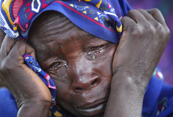 A Sudanese refugee cries moments after she and her family reach the safety of Bahai on the Chad border, on July 9 after hiding from Arab gunmen in the hills of Sudan's Darfur province for nearly a year.