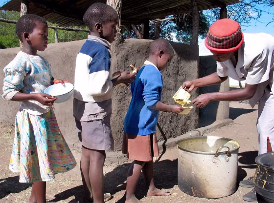Children at the Deli Primary School in Umguza, Zimbabwe,&nbsp;line up for an enriched corn and soy porridge provided by the U.N. World Food Program.