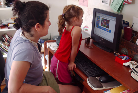 Amanda Cunningham watches as her 4-year-old daughter Madeline uses the computer in their New York apartment.