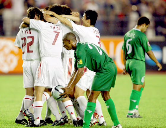Chinese players celebrate during Asian Cup quarterfinal win over Iraq in Beijing
