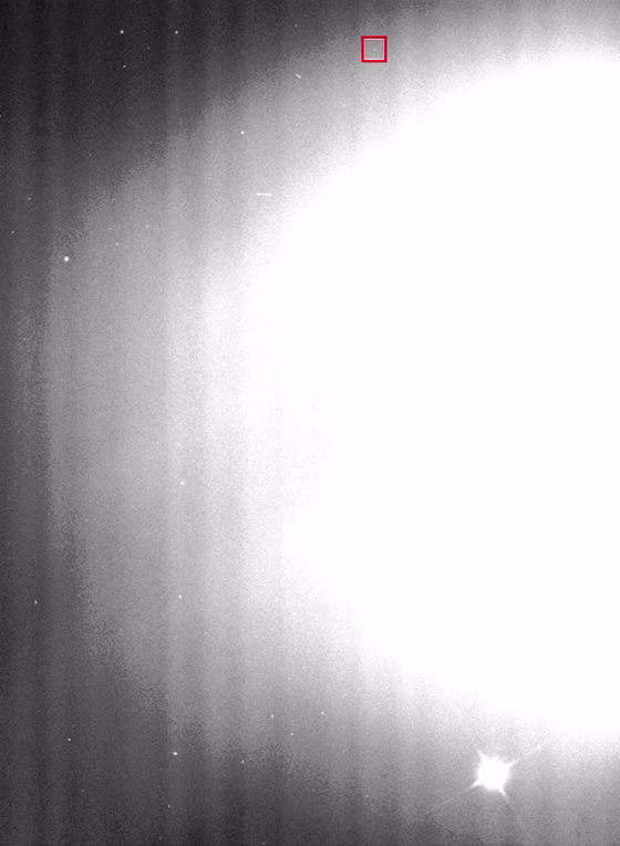 The moon known as S/2004 S1 shows up as a barely perceptible dot within the red square on this image, which is dominated by the light scattered by Saturn's rings and a larger moon at bottom right. Click on the picture to see more imagery from the Space Science Institute.
