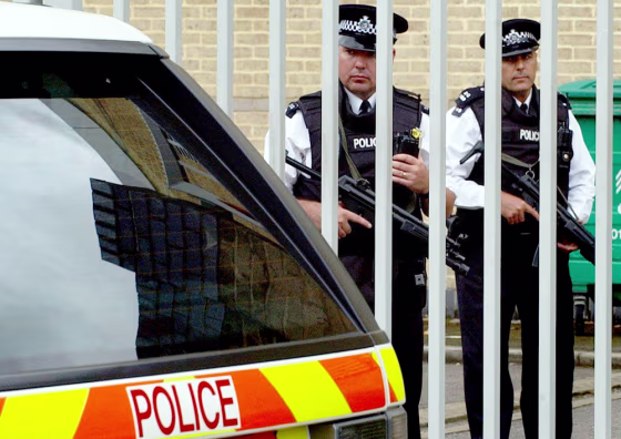 Armed police stand guard at Belmarsh Magistrates Court in London on Wednesday as terror suspects appear before the court inside.