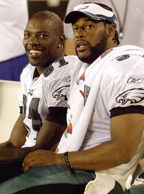 Eagles receiver Owens and quarterback McNabb watch the big screen TV during their 31-17 win over the Giants