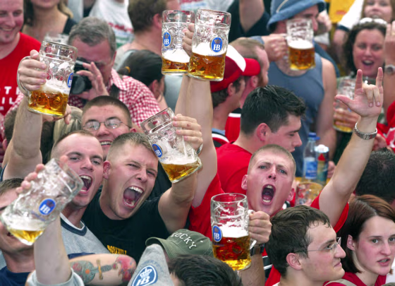 Guests cheer as they hold beer mugs during the opening ceremony of the Oktoberfest beer festival in Munich on Saturday.