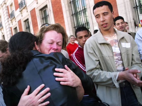 WOMAN IS EMBRACED BY IMMIGRANT DURING RALLY IN MADRID