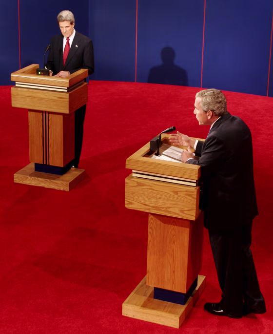 Sen. John Kerry, left, listens as President Bush answers a question&nbsp;Thursday.