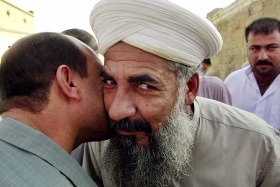 Sheik Khaled al-Jumeili, right, is welcomed by a friend after being released from U.S. custody on the orders of Iraqi interim Prime Minister Ayad Allawi on Monday.