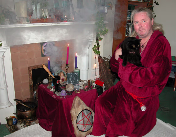 Kevin Carlyon, a high priest of British white witches,&nbsp;holds one of his&nbsp;10 black cats at his home in St. Leonards, Sussex.