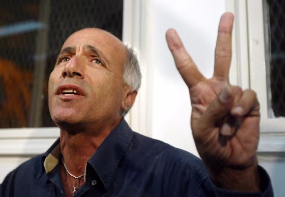Mordechai Vanunu gestures as he speaks with journalists at a court in Petach Tikva