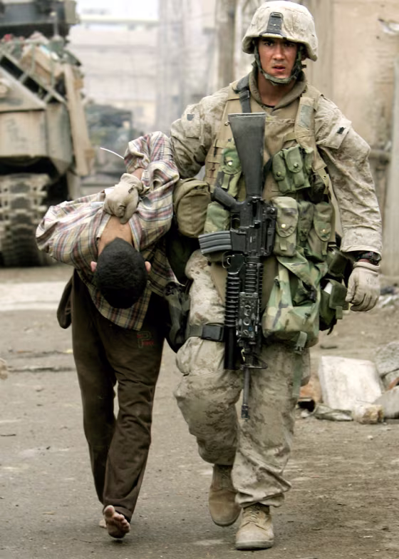 A U.S. Marine leads away a captured Iraqi&nbsp;in&nbsp;Fallujah on Friday.