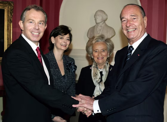 Prime Minister Tony Blair, left, shakes hands with&nbsp; President Jacques Chirac, right, as their wives, Cherie Blair, 2nd left, and Bernadette Chirac look on prior to their meeting Thursday.