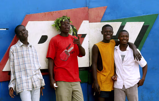 Anti-French protesters stand Thursday at the main gate to RTI, Ivorian Radio Television in Abidjan, Ivory Coast. 