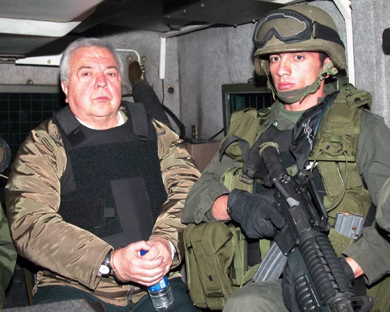 Rodriguez Orejuela is escorted by Colombian policemen before being extradited to the United States in Bogota