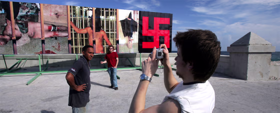 TAKING PICTURES IN FRONT OF BILLBOARD