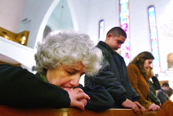 Iraqi Christians attend church service on Christmas Day in Baghdad