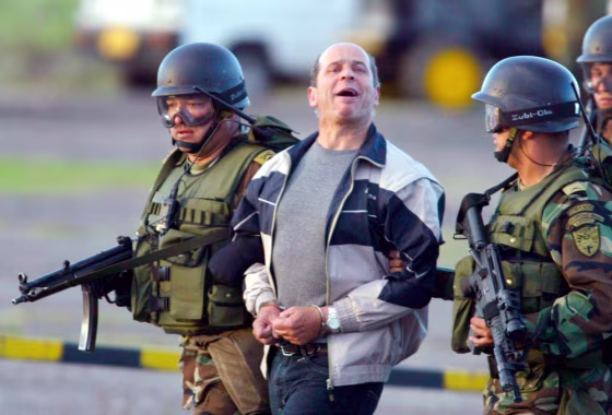 Rebel leader Ricardo Palmera is escorted by specials forces, at the military base in Bogota,&nbsp;after his arrest in Ecuador,&nbsp;Jan. 3, 2004.