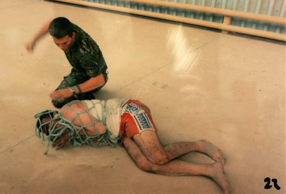 This picture, released by a British Court Martial on&nbsp;Tuesday, allegedly shows Lance Corporal Mark Cooley simulating a punch to an Iraqi detainee near Basra in May 2003.