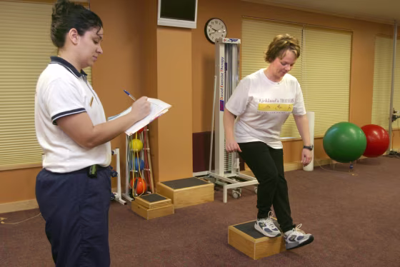 In a test of strength and balance, Denise defies the odds and actually completes a step down&nbsp;as physical therapist Michelle tries not to laugh.
