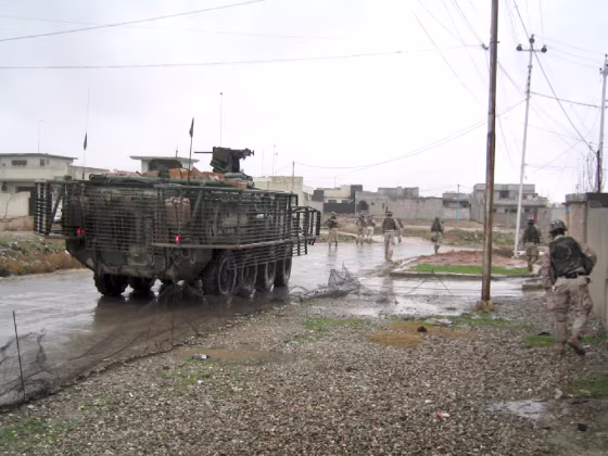 Soldiers from the 1st Platoon, C Company, 3d Battalion, 21st Infantry Regiment, enter the Al Wadah neighborhood in Mosul to encourage residents to vote in this weekend's national elections.