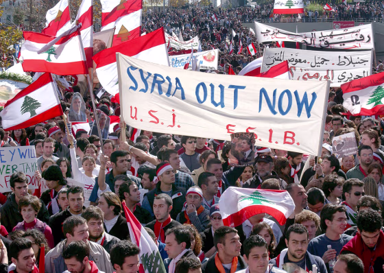 Protestors carrying Lebanese flags marched through much of Beirut on Monday, demanding that Syrian troops leave the country.