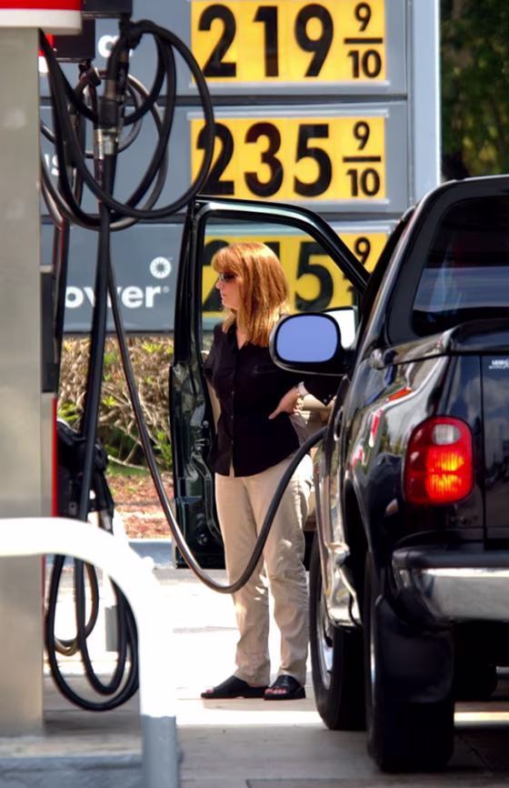 An unidentified woman fills&nbsp;her gas&nbsp;tank Monday in Miami. Average U.S. gas prices are at record highs around $2.10 a gallon, AAA reports.