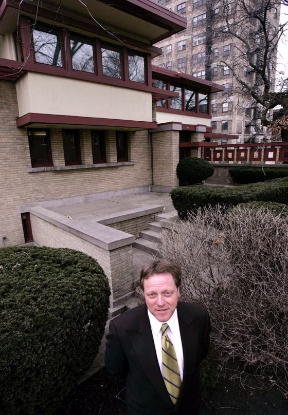 Frank Diliberto, whose company is handling the auction of the Emil Bach House, stands in front of the Prairie-style home designed by Frank Lloyd Wright.