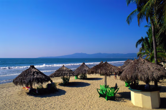 Grass umbrellas on beach, Puerto Vallarta, Mexico
