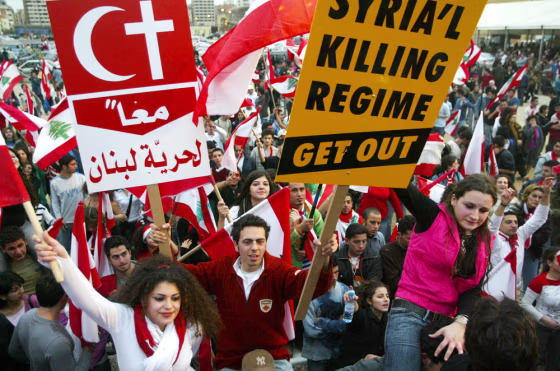 Lebanese protesters carry placards against Syria in Beirut