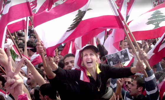 Protestors wave Lebanese flags during a demonstration against Syria in Beirut on Monday.