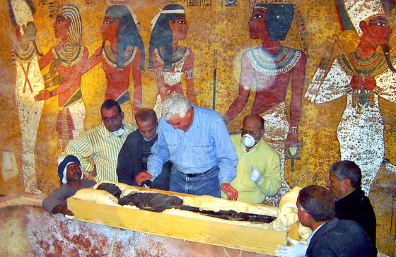 Zahi Hawass, the head of the Egyptian Supreme Council for Antiquities, center, checks the 3,300-year-old mummy of the ancient King Tutankhamun at his tomb in Luxor, Egypt.