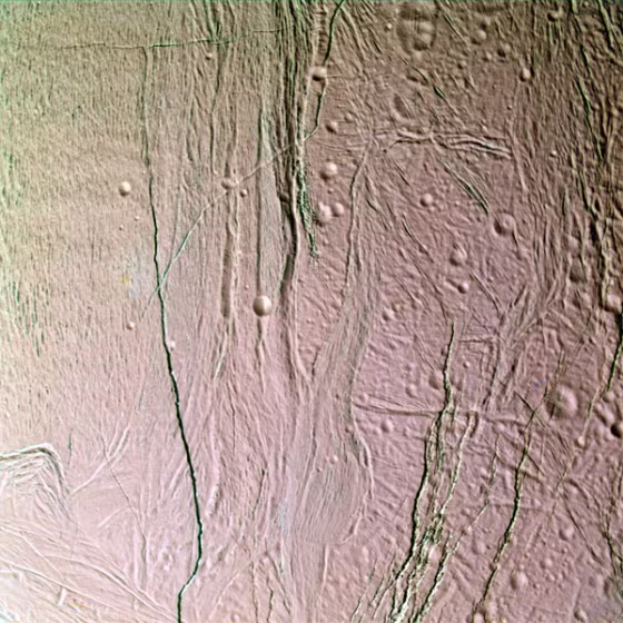This false-color, close-up look at Enceladus yields new insight into the different processes that have shaped the moon’s icy surface. Extending through the center of this image, a system of two-mile (three-kilometer) wide rifts and 12-mile (20-kilometer) wide lanes of grooved terrain separate two distinct geological provinces on Enceladus. To the right of the boundary is older, cratered terrain. 