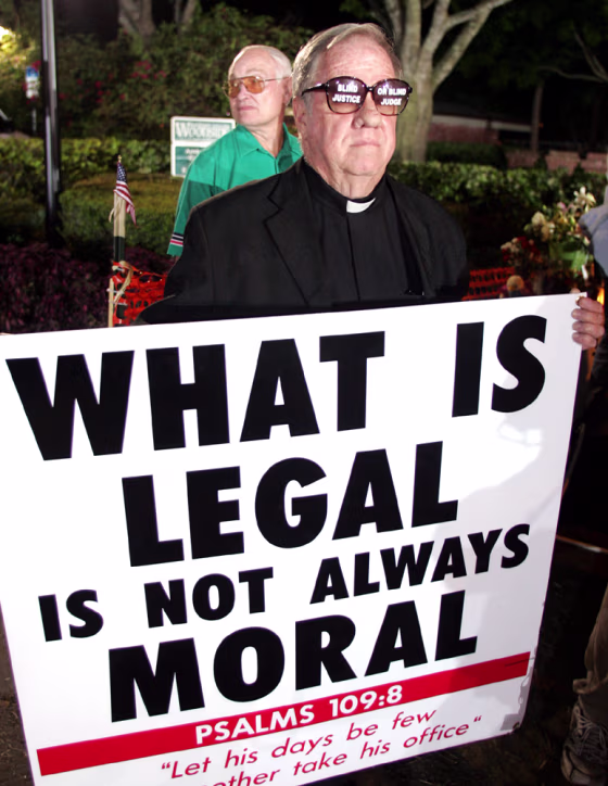 Chaplain John Butler Book shows his support for Terri Schiavo outside the Woodside Hospice in Florida