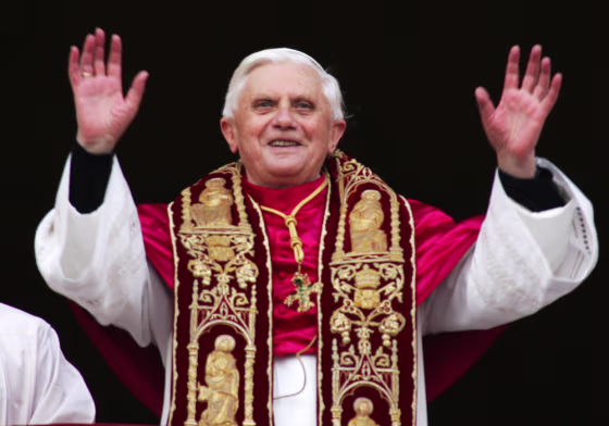 Pope Benedict XVI waves to the crowd from the central balcony of St. Peter's Basilica on Tuesday.