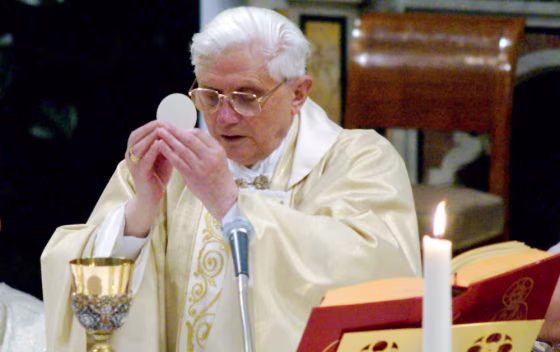 Pope Benedict XVI, Cardinal Joseph Ratzinger of Germany, elevates the host as he leads a mass in the Sistine Chapel at the Vatican