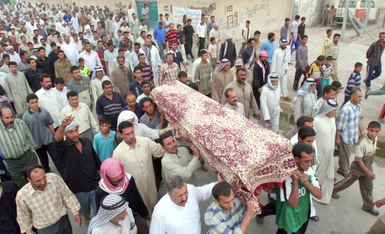 Iraqis carry the coffin of a man killed when suicide car bombs exploded Sunday near a market in a Shiite-dominated neighborhood of Baghdad.