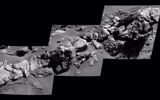 An exposure of bedrock dubbed "Larry's Outcrop" on the flank of "Husband Hill" inside Mars' Gusev Crater shows little layering in this view. NASA's Mars Exploration Rover Spirit used its panoramic camera in May 2005 to take the images combined into this mosaic.