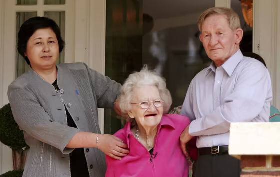 Jenkins holds onto his mother on the porch of his sister's home in Weldon