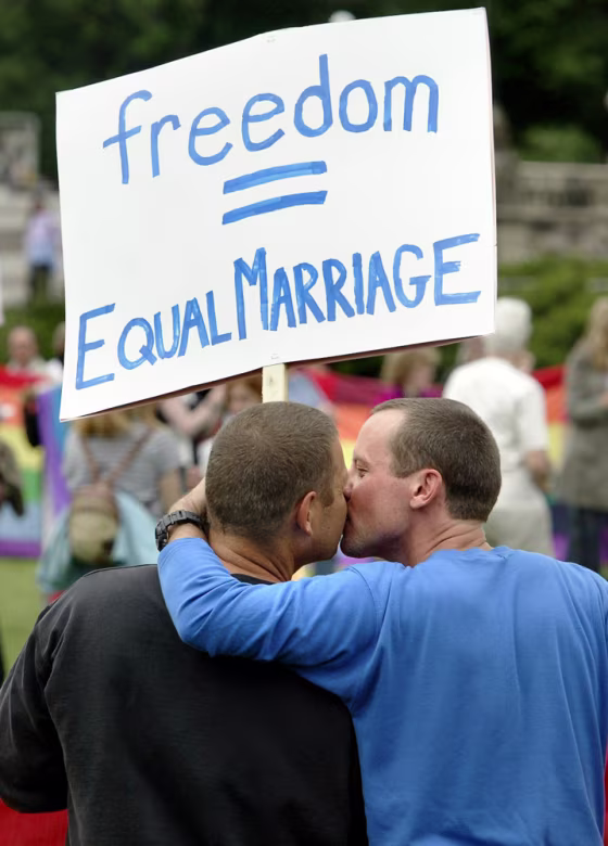 Alex, left, and his partner, Jason, take part in a rally for equal marriage on Parliament Hill in Ottawa, Canada, in this June 19 file photo. Canada on Tuesday became the third country to legalize same-sex marriage.