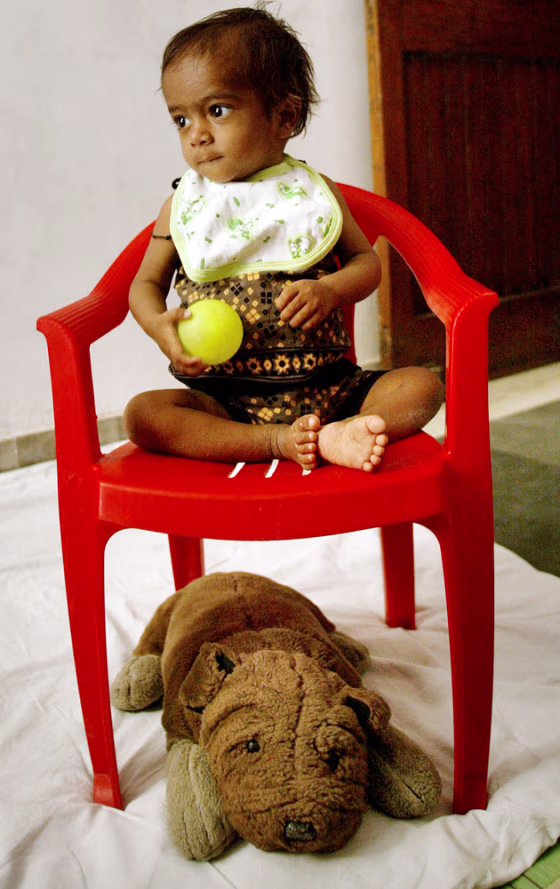 A 14-month-old, HIV-positive girl plays at Akanshya, a day home care run by a women's action group who looks after HIV positive people and their families, in New Delhi, India, June 1.&nbsp;&nbsp;&nbsp;&nbsp;&nbsp;&nbsp;&nbsp;&nbsp;&nbsp; 