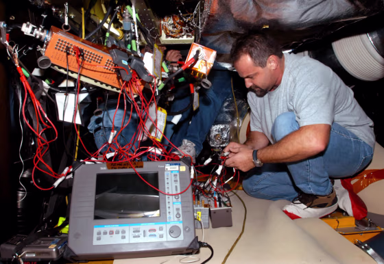 Technician Aaron Sherman performs tests on space shuttle Discovery in Cape Canaveral