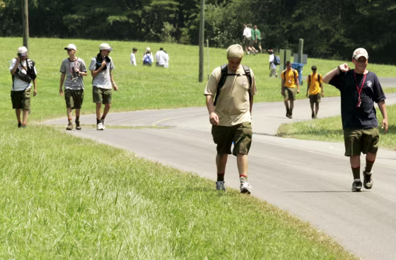 A group of Boy Scouts walk back to their base camp at Fort A.P. Hill in Bowling Green, Va., on Tuesday, a day after the deaths of four Boy Scout leaders at the National Jamboree being held there.