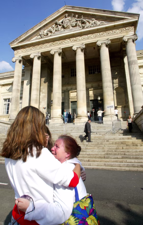 An unidentified woman cries Wednesday outside the courthouse&nbsp;in Angers,&nbsp; France, after a verdict in a mass pedophilia trial that scandalized the nation. 