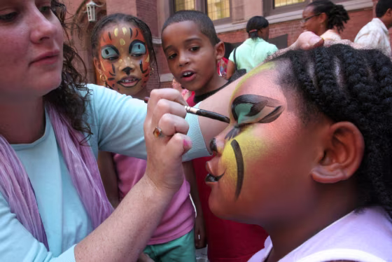 Jennifer Wade, left, paints the face of 8-year-old Jamillah Horton of New York at 4-H Family and Youth Day on July 20. 4-H and another group with roots in farming, the National FFA Organization, are reaching out to city kids with projects and hobbies often unrelated to agriculture.