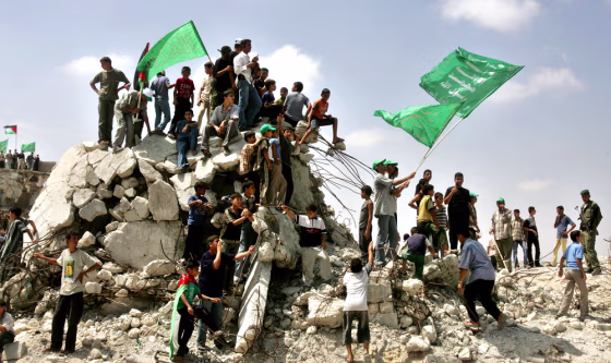 Palestinians wave Hamas flags during rally in early celebrations for Israel's imminent pullout in Gaza Strip