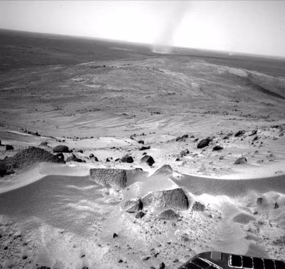 NASA's Spirit rover has rolled into position for a grand view atop Husband Hill on Mars. Dust devils scoot across the landscape in the background.