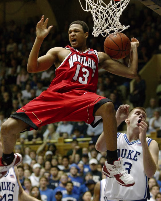 Maryland's Chris McCray celebrates after dunking against Duke