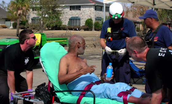 Rescue workers transport 76-year-old Gerald Martin who was found by members of the FEMA Urban Search and Rescue, California Task Force 3, Friday, in New Orleans.
