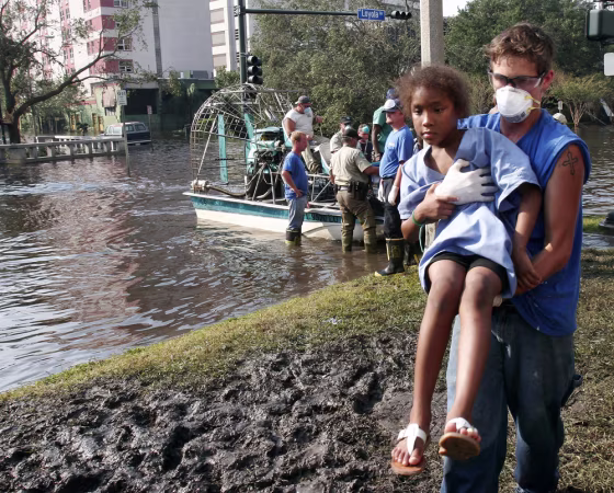 A young patient at Charity Hospital in New Orleans is carried to a waiting bus after being evacuated by airboat on Sept. 2.